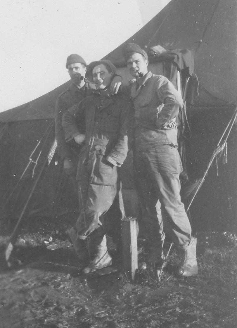 Three ground crew smoking pipes at the unknown airbase